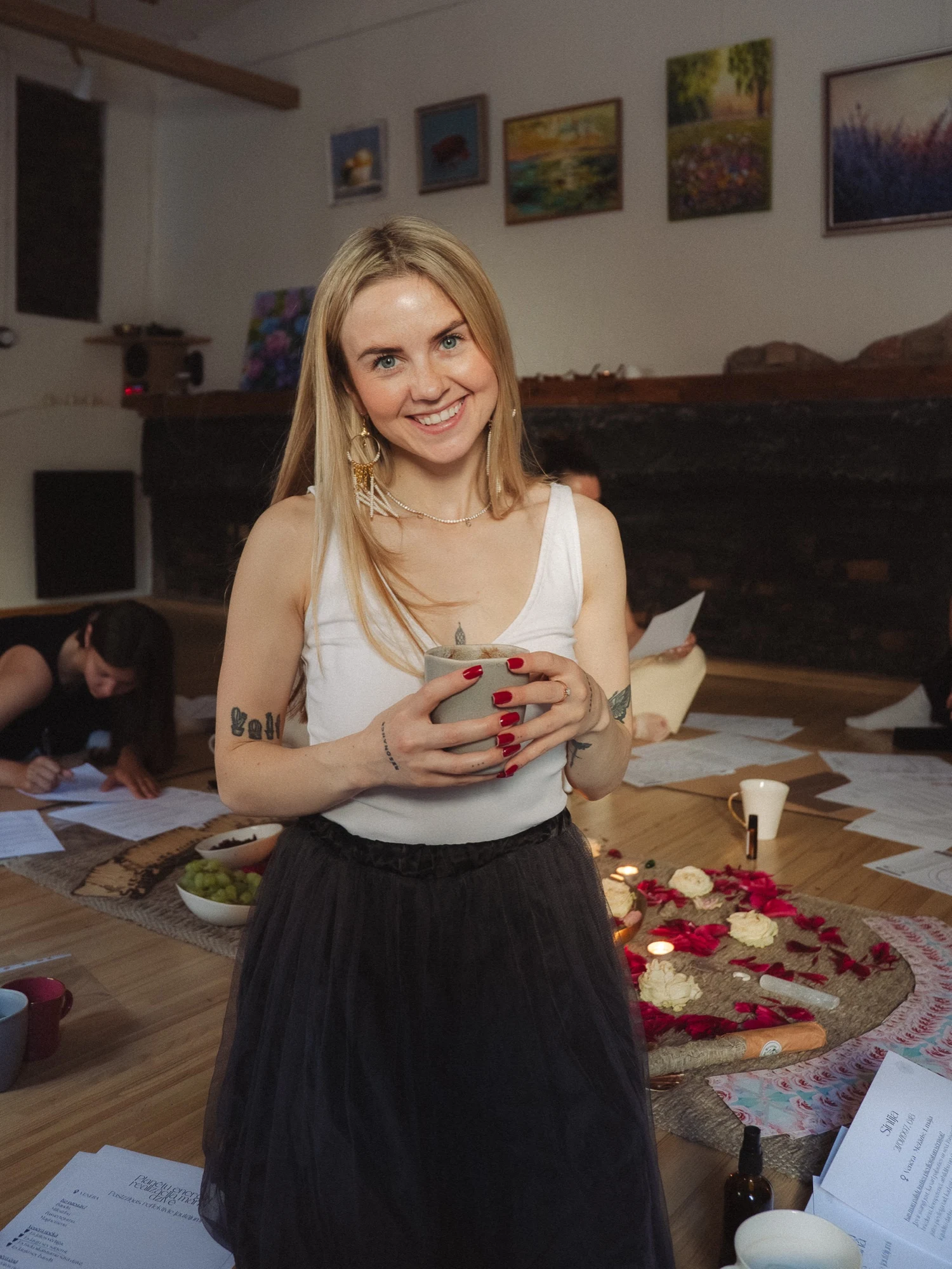Sintija Kaui holding a cup of cacao in the women’s circle space.